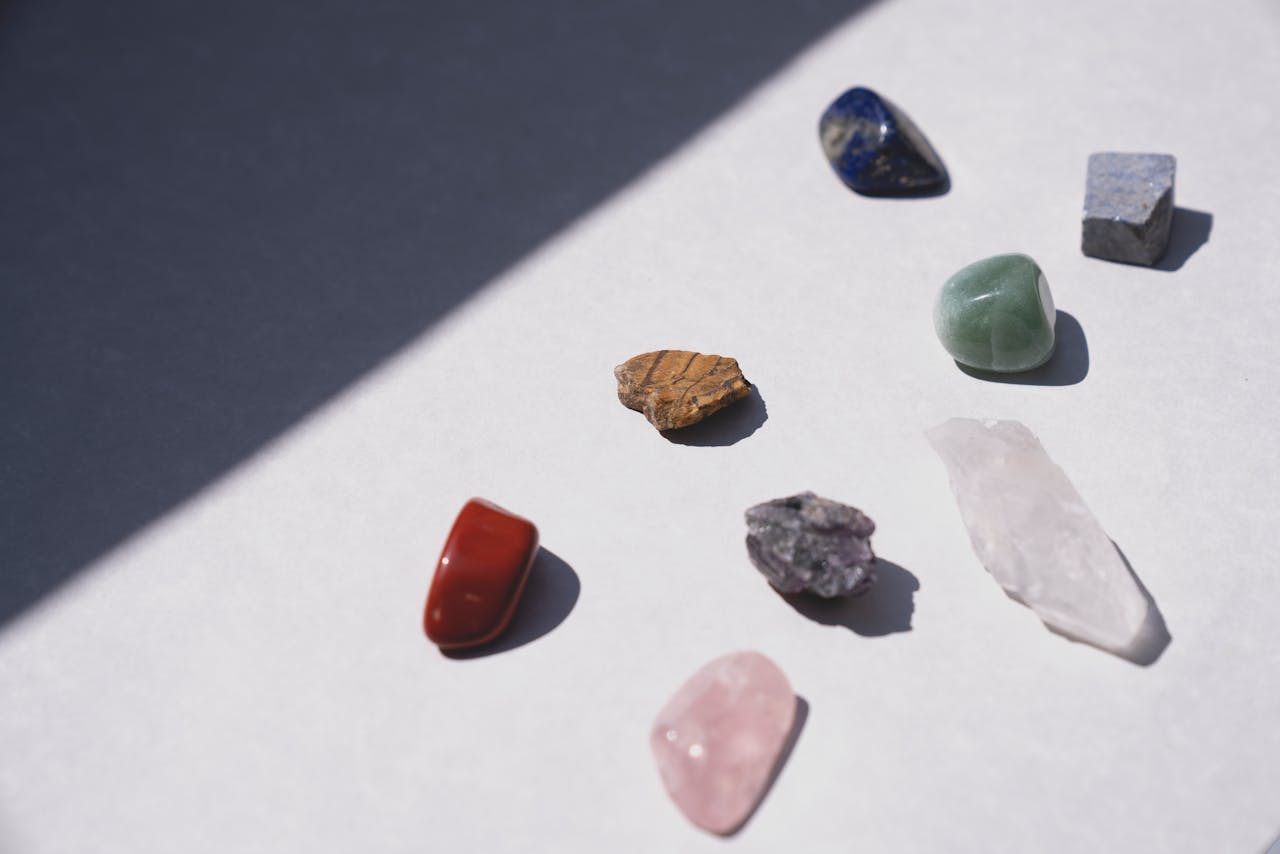A variety of healing crystals displayed on a white surface, perfect for spiritual and energy-focused projects.